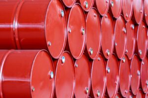 Rows of red industrial barrels stacked in an orderly fashion.